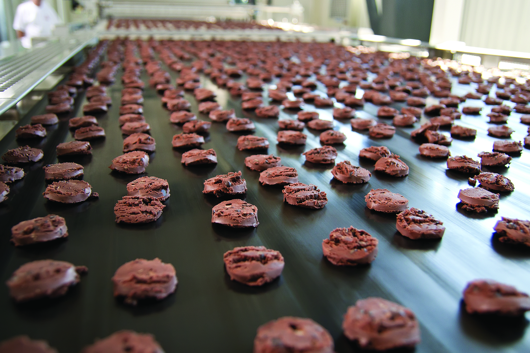 Off-spec chocolate products are diverted from the production line to be reworked.